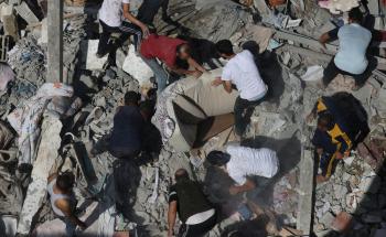 Residents search for survivors in the destruction caused by airstrikes in Gaza.