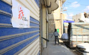 Doctors Without Borders (MSF) load trucks for distribution at Atmeh Hospital