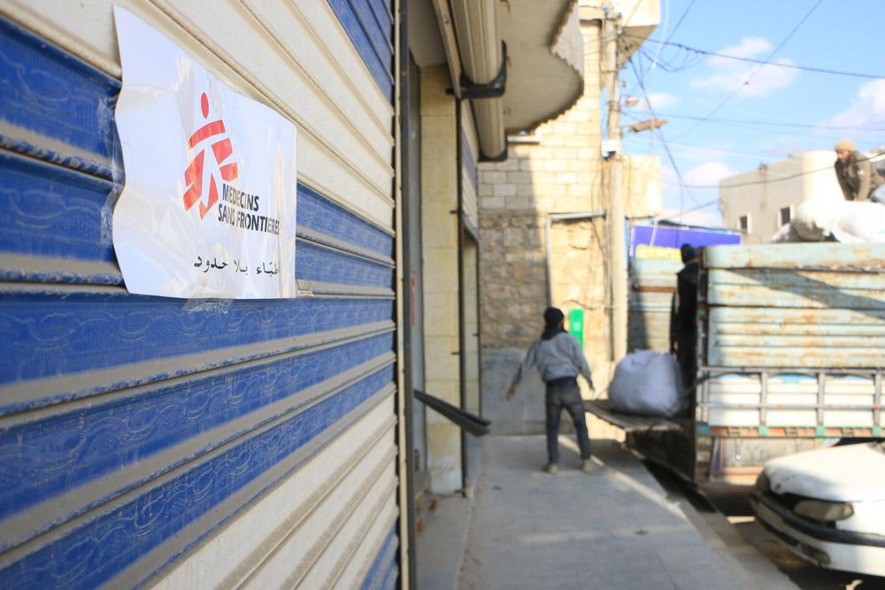 Doctors Without Borders (MSF) load trucks for distribution at Atmeh Hospital
