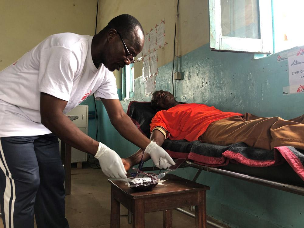 Doctors Without Borders (MSF) laboratory technician testing blood for malaria
