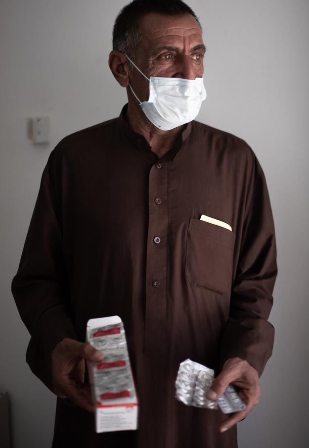 Patient holding the new oral treatment he’s currently taking in National Tuberculosis Institute, Baghdad Medical City, Baghdad, Iraq.