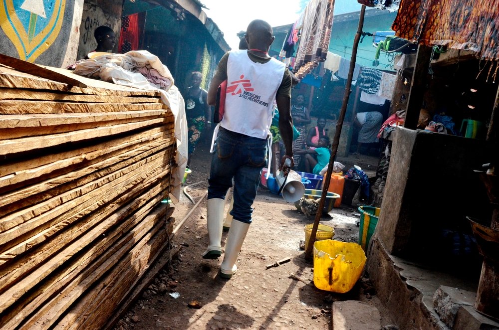 Musa, MSF's health promoter, going into the slum of Moa Warf. Photo: Alessandro Siclari