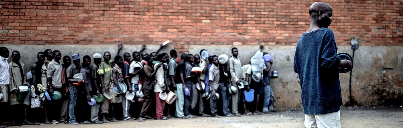Men line up while waiting for the only meal of the day to be served. Nutrition is a major concern in Malawi central prisons as inmates receive an inadequate supply of food in terms of quantity, nutritional value and calorie intake. Photo: Luca Sola