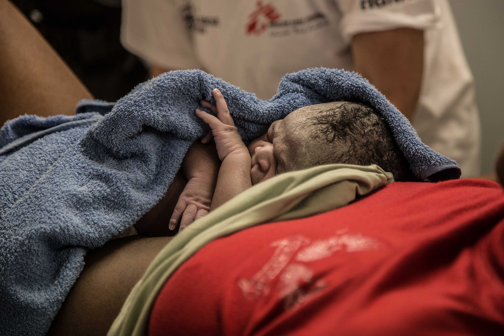 Astrid, MSF midwife helps Collins deliver a baby boy, Divan, on board of Dignity I. The delivery went smoothly. Photo: Marta Soszynska