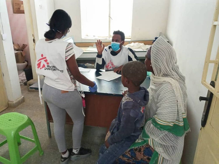 An MSF nurse and a translator prepare a donation of medical materials in Megab,