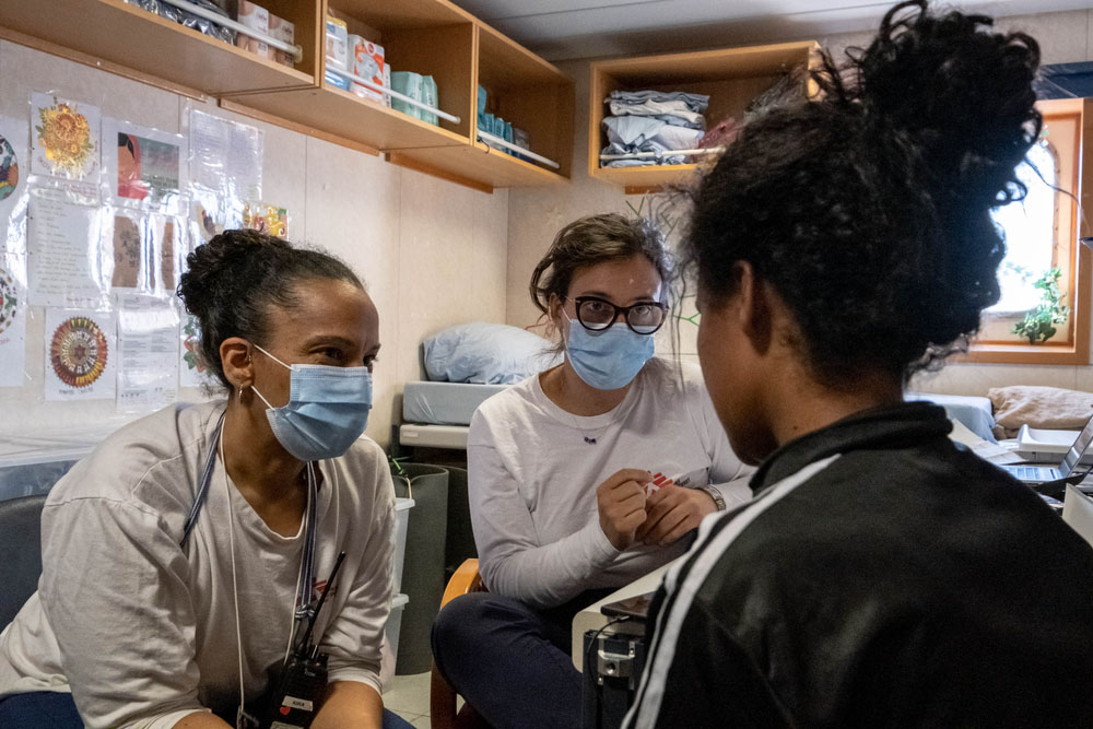 MSF midwife Kira (left) and psychologist Graziana (middle) talk with Julia* during a medical consultation.