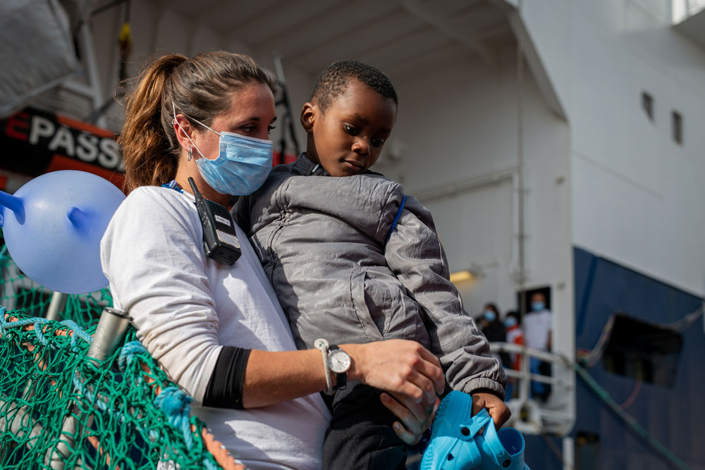 MSF Team member carries one of the rescued children
