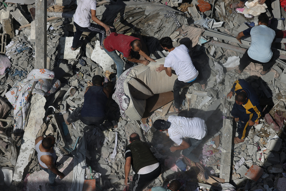 Residents search for survivors in the destruction caused by airstrikes in Gaza.