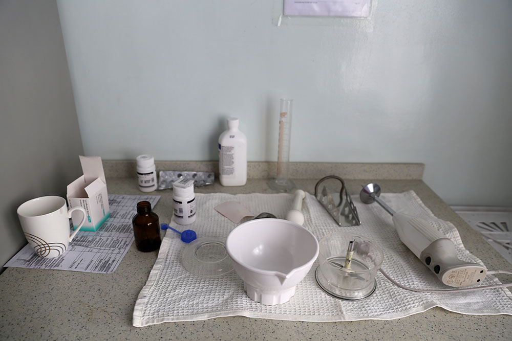 MSF staff grind tablets and turn them into a syrup, making it easier for child TB patients to digest their medication,2017