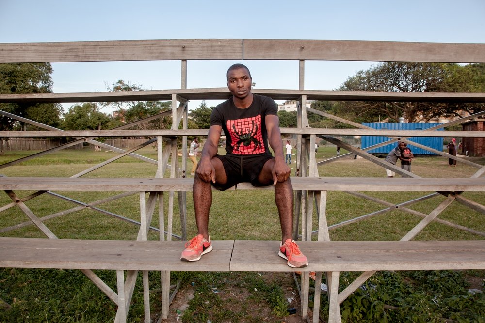 Mozambican Fabian (28) sits on the stands of the Isipingo sports field