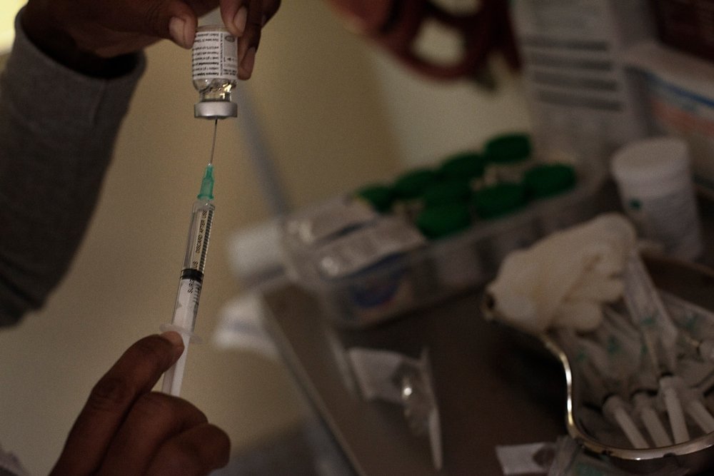 Patients co-infected with HIV and drug-resistant (DR) TB sit waiting to receive medication