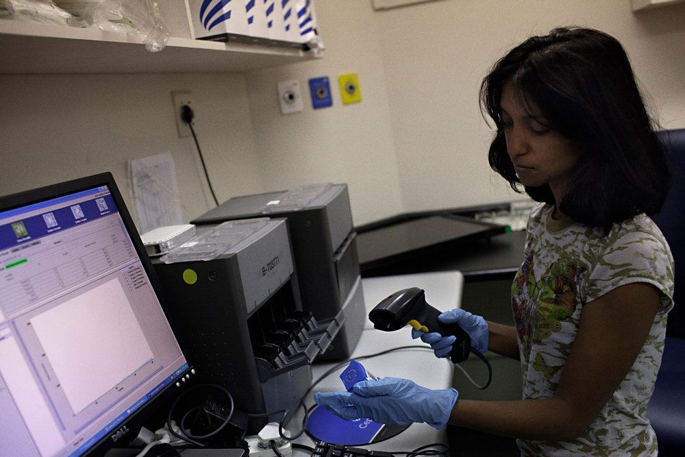 Medical officer Neisha Mohess, scans a sample of sputum for loading into an automated molecular TB diagnostic machine called GeneXpert.
