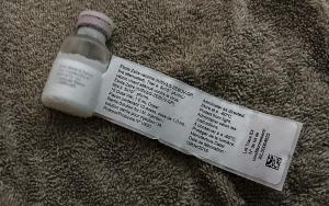 A glass bottle of white liquid