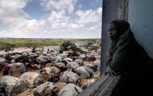 A woman looking outside an internally displaced people camp