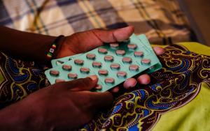 Ether, an advanced HIV patient, with her medication in her hands, in a female ward at Nsanje District Hospital, Malawi. 