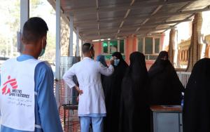MSF staff ushering patients into the hospital in Afghanistan