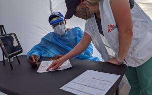 Doctors Without Borders(MSF) team members set up one of the private medical consultation kiosks at a mobile testing and health clinic in Immokalee, Florida, designed to address some of the unmet health needs of the large community of migrant farmworkers in the area during the COVID-19 outbreak.