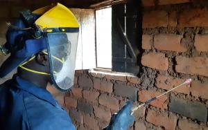 A sprayer is treating a house against mosquitoes during the 2019 indoor residual spraying campaign in Kinyinya health district.