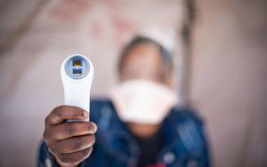 A picture of a healthworker holding a thermometer in Eshowe