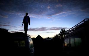 MSF staff member standing on an MSF vehicle while on a mission to reach people with sleeping sickness.
