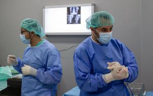 MSF surgical team in the OT performing an intervention on a patient wounded in the Great March of Return protest, February 2020, Al Awda Hospital, Jabalia, northern Gaza.