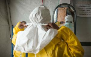 A staff worker gears up in PPE to work with Ebola patients