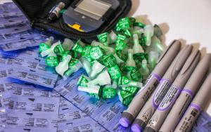A collection of insulin pens and needle caps beside a glucometer used to treat diabetes at the MSF clinic in Arsal, north Lebanon