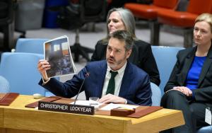 MSF’s Christopher Lockyear holds up an image of the destroyed MSF shelter in Al-Mawasi in Khan Younis, Gaza. Attacks on medical care are devastating