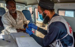 an MSF nurse collects a blood sample from a patient suspected of having Hepatitis C