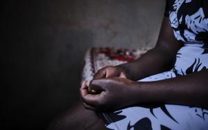 a woman sits with her hands in her lap. sex workers are often victims of sexual and gender-based violence