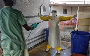 A health worker being disinfected with chlorine at the Ebola treatment center
