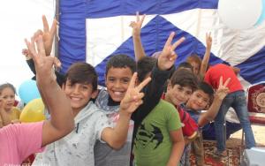 Child health: A group of boys smile and give the peace sign