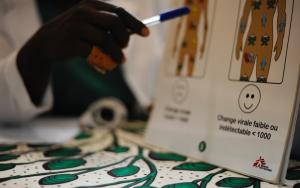 A doctor pointing to an medical illustration of the effects of HIV