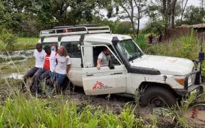 MSF logistics team crossing the river after the bridge was washed away