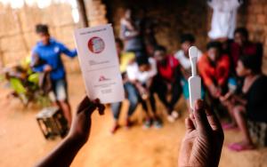 A picture of a woman holding an HIV self test