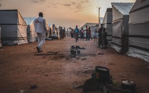 An MSF staff member walks through Mbawa internally displaced people's camp, where most of the displaced were uprooted by the so-called ‘farmer-herdsmen’ conflict. Benue state, Nigeria, June 2020.