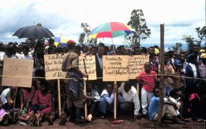 KIGALI, RWANDA, AFRICA, 30.04.95. Tutsi survivors of the genocide at the one year anniversary of the genocide. Beneath umbrellas. 