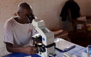 An MSF doctor looks through a microscope to check for Sleeping Sickness 