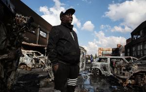 15 July 2021. A business owner surveys the damage to his panelbeating workshop in Malvern, Johannesburg. Social violence and exclusion has devastating consequences. Picture: James Oatway. 