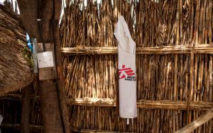 MSF vest hanging on a reed fence.