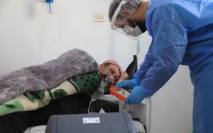 Nurse checking a patient’s oxygen level inside the ward for patients with suspected COVID-19.