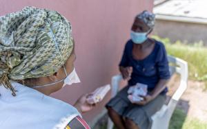 Patient (Phenduka Mtshali) infected Drug Resistant Tuberculosis (DR-TB), at her home in Mbongolwane, South Africa speaking with our MSF fieldworker, Jabulile.