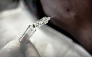 A picture of a lumbar puncture being performed on a patient.