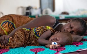 A child 14 months old is sleeping with her mother at the Muanda Measles Treatment Center in the Democratic Republic of Congo where she is being treated for measels. 