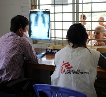 A doctor views a chest x-ray and consults with a patient as part of the MSF Active Case Finding TB programme, Tboung Khmum, Cambodia