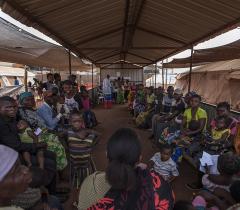 Refugees wait to be vaccinated at the MSF clinic in the Cacanda camp