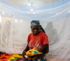 A mother cradles her sick baby in the children’s ward at Mora General hospital. Far-North, Cameroon, March 2020.