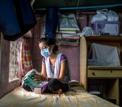 An XDR-TB patient looking at her boxes of TB medication in Mumbai, India