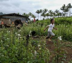 Displaced children playing in the open fields in Cambodia