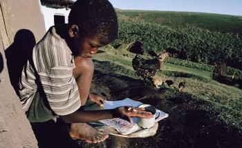 A young child looking at ARV medication for HIV/AIDS